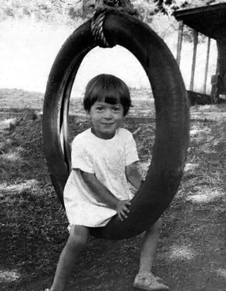 Child on tire swing